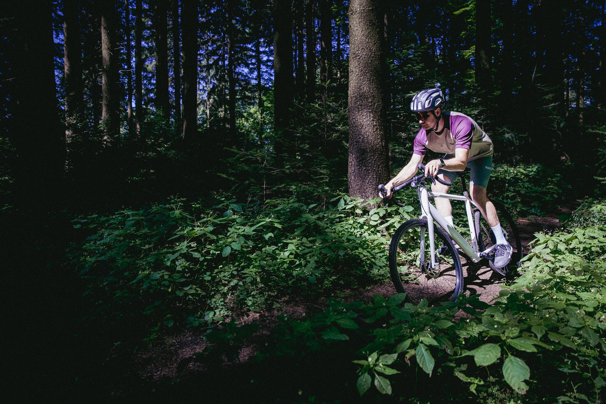 Mann fährt auf Gravel-E-Bike Torino GRV von Coboc durch Wald
